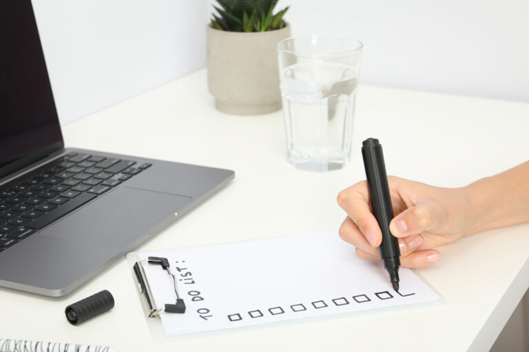 How to Choose the Right Outsourcing Partner Without Guesswork A person marking a checklist to define goals for an outsourcing collaboration.