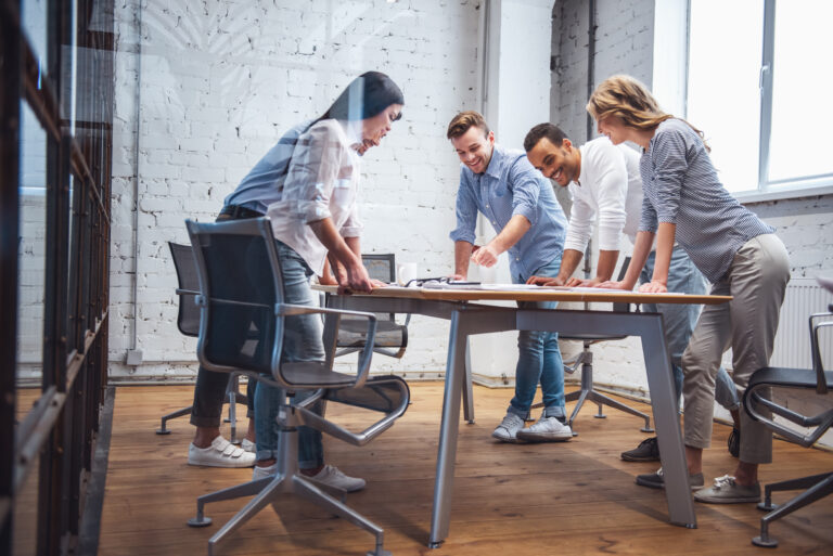 Outsourcing vs. Hiring In-House: Which Wins for Your Business? A collaborative team meeting discussing the cultural impact of outsourcing vs. hiring in-house.