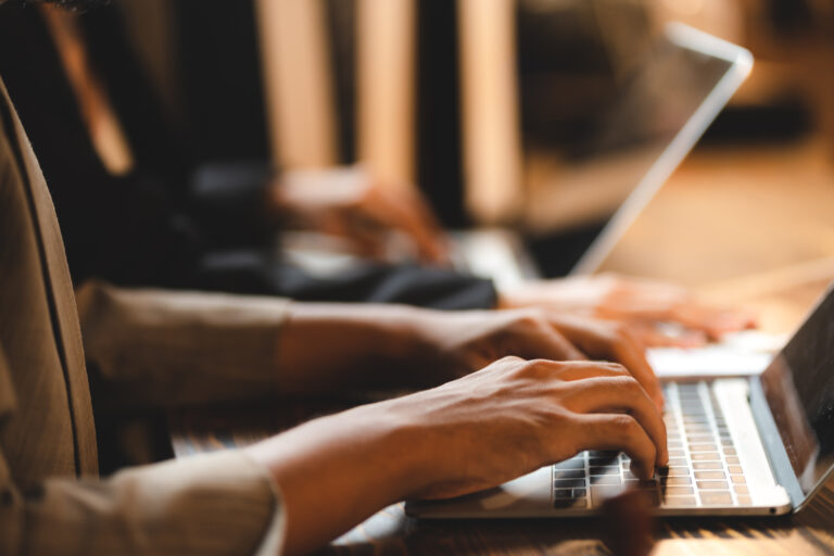 How to Choose the Right Outsourcing Partner Without Guesswork professional business person typing on computer laptop desk at office, using keyboard technology